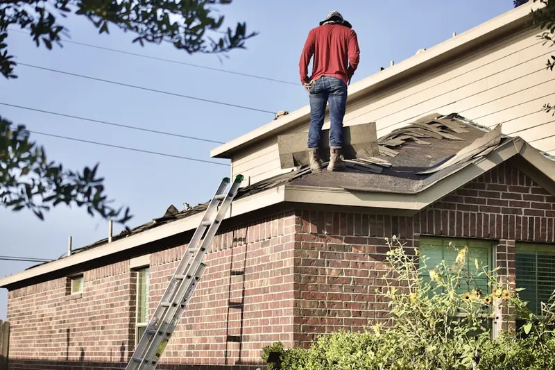 Professional roofer working on a residential roof in Virginia Heights